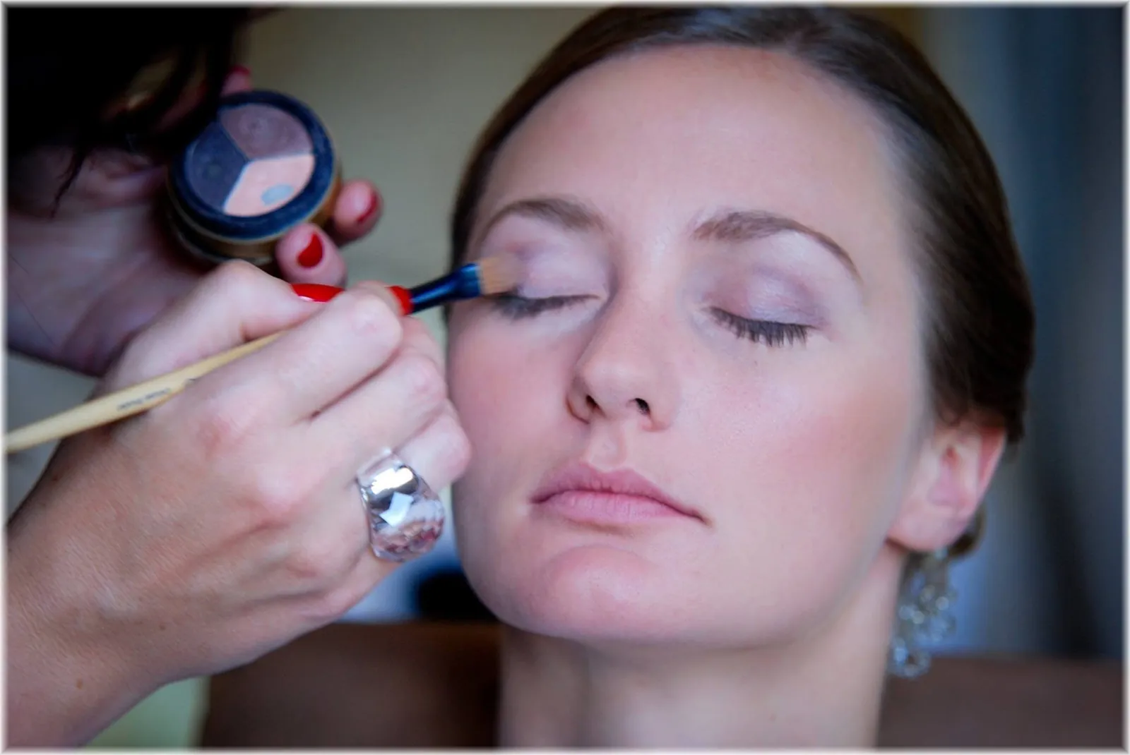 Gini applying eyeshadow during a makeup lesson