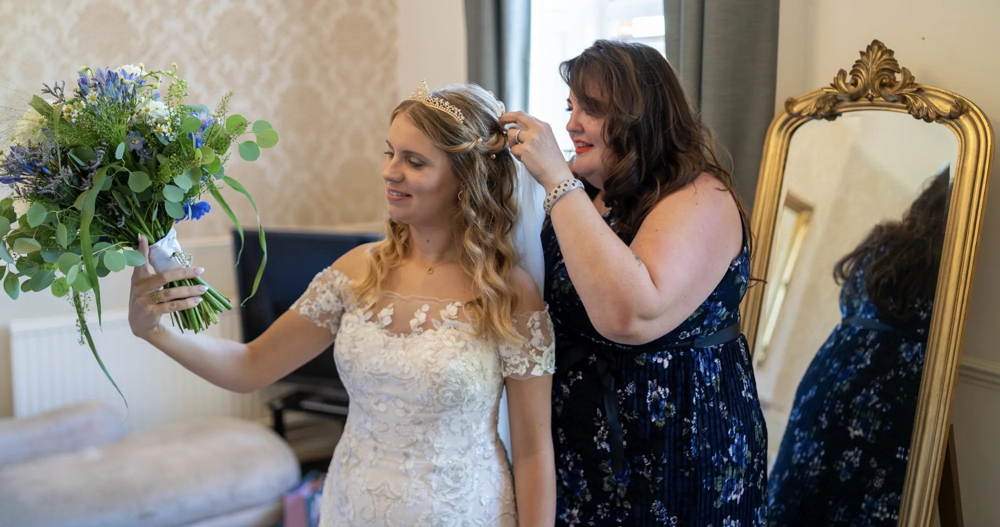 Gini styling a bride's hair by the mirror