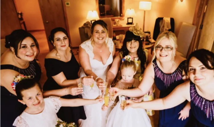 A bride and her bridal party raising a toast on the wedding morning