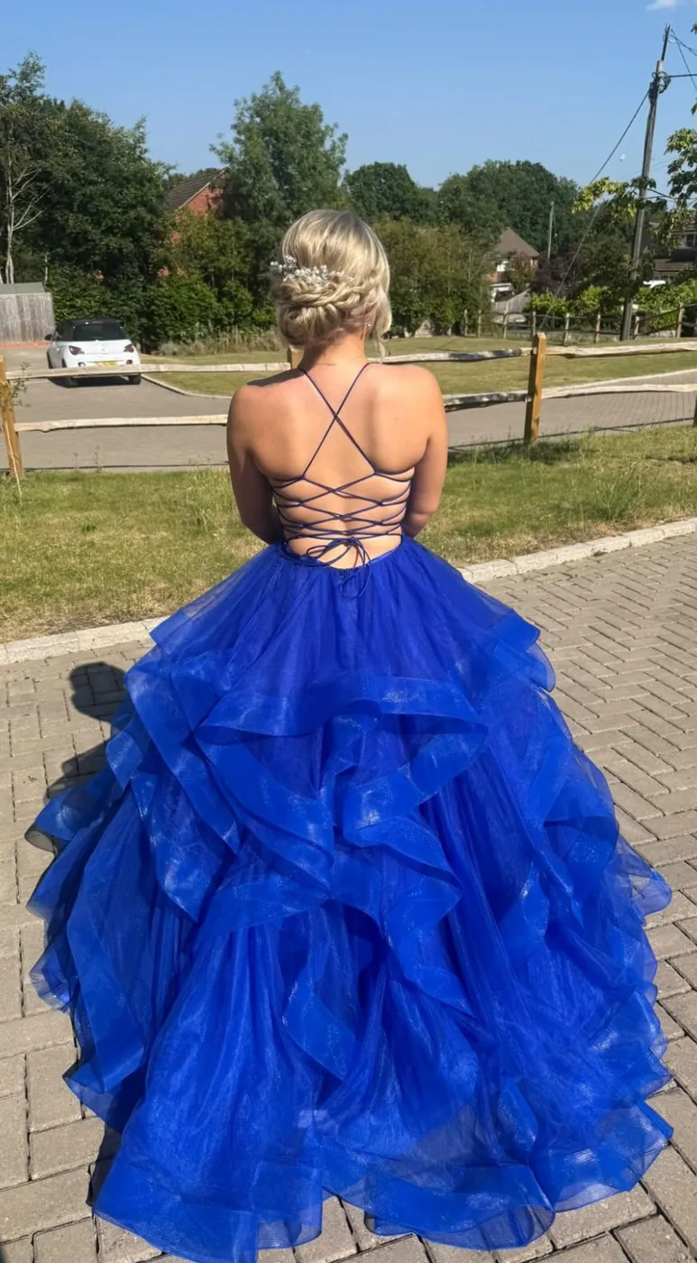 Prom-goer in a blue ball gown with a braided updo