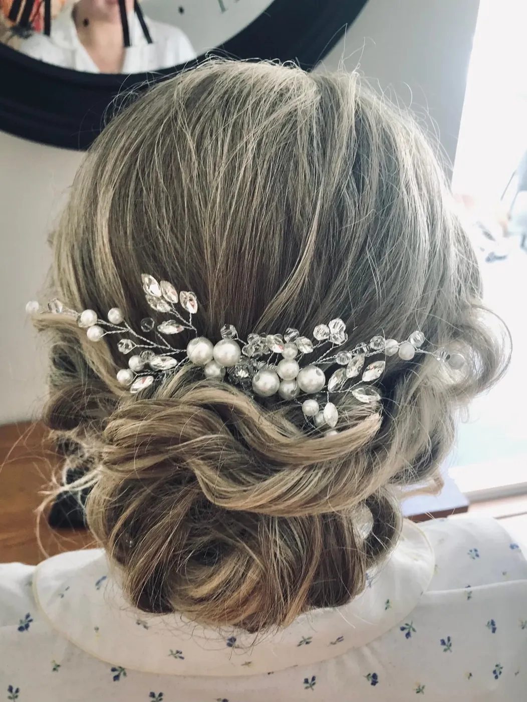 Low prom updo with a pearl hair vine