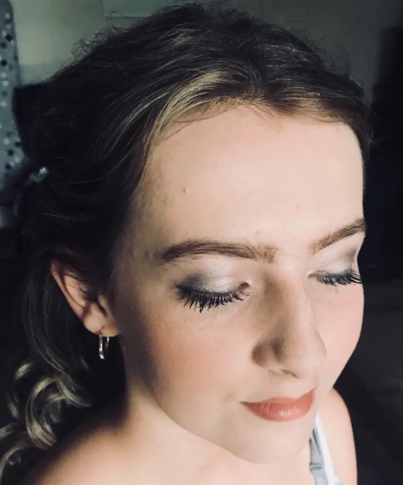 Prom makeup with soft bronze eyes and loose waves